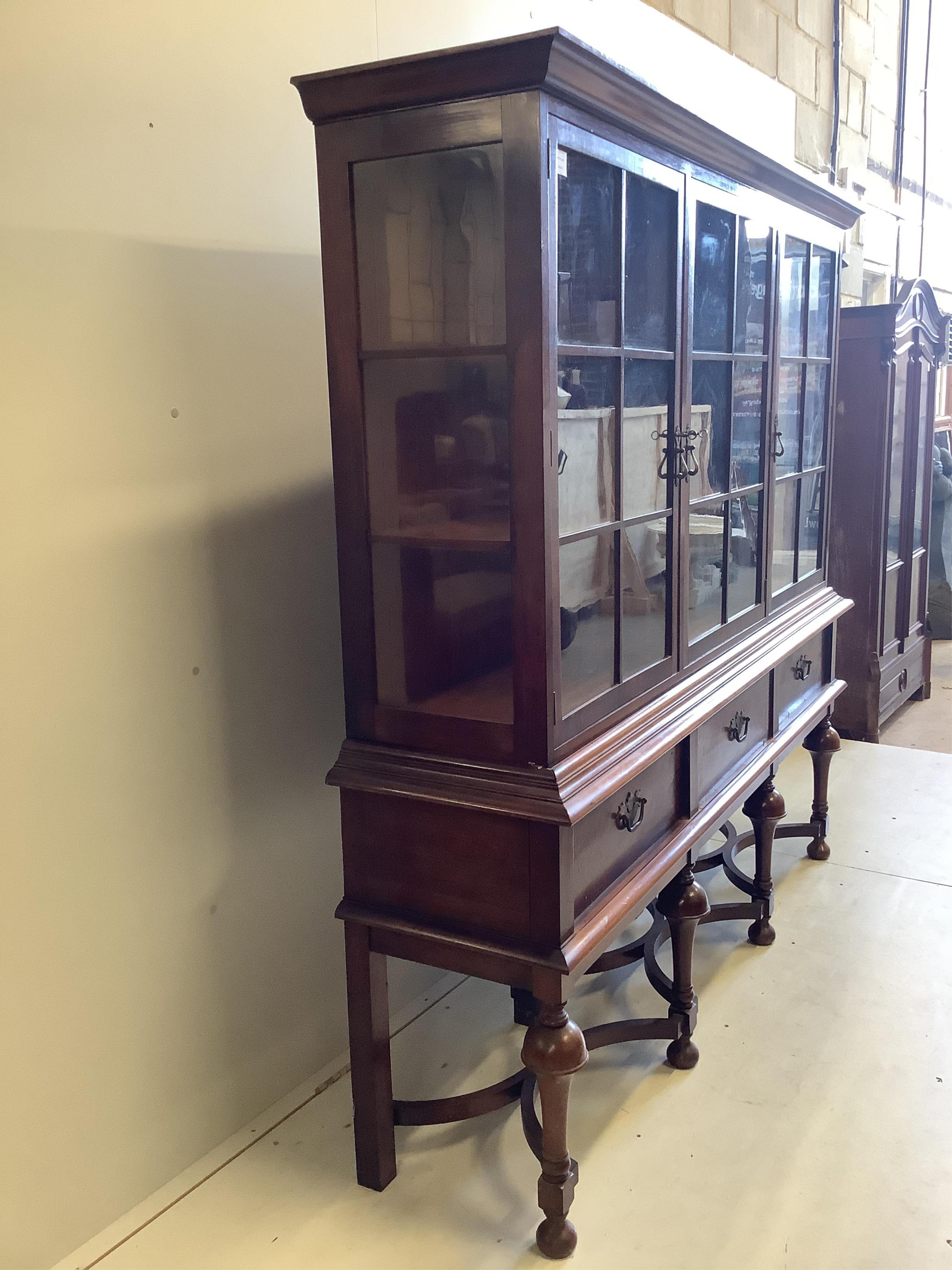 An early 20th century Dutch style walnut display cabinet, width 188cm, depth 44cm, height 180cm. Condition - fair to good